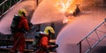 Panorama Firefighter team using water fog spraying down fire from oil rig factory explosion