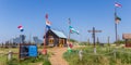 Panorama of flags and a little cottage on Texel island