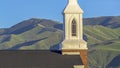 Panorama Focus on the roof and steeple of a church with classic red brick exterior wall Royalty Free Stock Photo