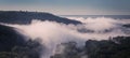 Panorama with fog over hills