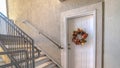 Panorama frame Apartment front door with welcome mat and wreath Royalty Free Stock Photo