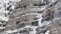 Panorama frame Bridal Veil Falls in Provo Canyon with frozen water on steep slopes in winter