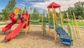 Panorama frame Bright colorful childrens playground under blue sky and clouds on a sunny day