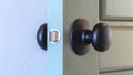 Panorama frame Close up of a round black door knob installed on a gray paneled interior door Royalty Free Stock Photo