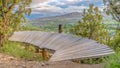 Panorama frame Curving elevated boardwalk descending into valley