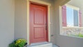 Panorama frame Facade of home with red front door and wooden shutters on the sliding window Royalty Free Stock Photo