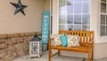 Panorama frame Facade of a home with a wooden bench on the welcoming front porch