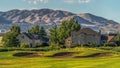 Panorama frame Fairway and bunker of golf course in front of homes with lake and mountain view Royalty Free Stock Photo