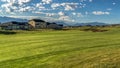 Panorama frame Fairway of a golf course with view of houses and mountain in the background Royalty Free Stock Photo