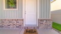 Panorama frame Front door and porch of home with hello mat