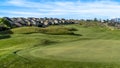 Panorama frame Golf course and homes under blue sky with clouds viewed on a sunny day Royalty Free Stock Photo