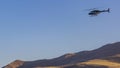 Panorama frame Helicopter flying over an immense mountain with clear blue sky background