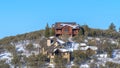 Panorama frame Hill top houses in Park City Utah amidst scenery of snow and blue sky in winter Royalty Free Stock Photo