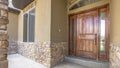 Panorama frame Home porch and brown wood front door with sidelights and arched transom window