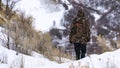 Panorama frame Man standing alone on a slope blanketed with powdery snow in winter