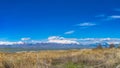 Panorama frame Panorama of a mountain with snowy peak towering over a lake with grassy shore