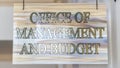 Panorama frame Office Of Management And Budget sign hanging on decrative wrought iron hanger