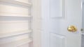 Panorama frame Open door showing interior empty white shelves