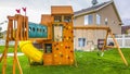 Panorama frame Playground structure with slide swings playhouse tower and climbing wall Royalty Free Stock Photo