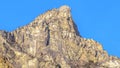 Panorama frame Precipitous slope of a rocky mountain gainst clear blue sky in Provo Canyon