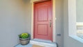 Panorama frame Red wooden front door at the entrance of a home with concrete exterior wall Royalty Free Stock Photo