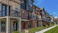 Panorama frame Row of homes with porches and small balconies under blue sky on a sunny day Royalty Free Stock Photo