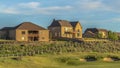 Panorama frame Sand trap and fairway at a golf course with multi storey homes in the background Royalty Free Stock Photo