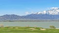 Panorama frame Scenic view of lake and grassy field under blue sky on a sunny day Royalty Free Stock Photo