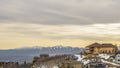 Panorama frame Scenic winter view of houses on a snowy mountain against cloudy sky at sunset