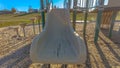 Panorama frame Slide on a playground with the sun shining brightly in the background