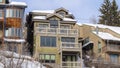 Panorama frame Snow and icicles on roofs of mountain homes in Park City Utah during winter Royalty Free Stock Photo