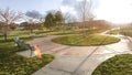 Panorama frame Vast park with pathways and trees on the grassy ground under the blazing sun Royalty Free Stock Photo