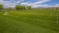 Panorama frame Vast sports field with soccer goal net and baseball bleachers behind a fence Royalty Free Stock Photo