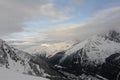 Panorama of French Alps with mountain ranges covered in snow and clouds in winter Royalty Free Stock Photo