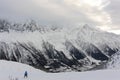 Panorama of French Alps with mountain ranges covered in snow and clouds in winter Royalty Free Stock Photo