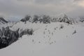 Panorama of French Alps with mountain ranges covered in snow and clouds in winter Royalty Free Stock Photo