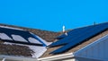 Panorama Snow and photovoltaic solar panels on a roof Royalty Free Stock Photo