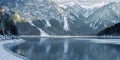 Panorama of the frozen icy lake Plansee with stones on the ice in reutte in the evening