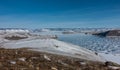 Panorama of the frozen lake. The icy surface is covered with snow, like lace