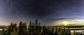 Panorama of full moon and stars in clear sky shines over Scandinavian wild forest, lakes, swamps, long exposure night photo,