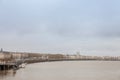 Panorama of the garonne quay quais de la garonne, in Bordeaux, france with the Saint Andre Cathedral behind during a winter