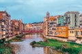 Panorama of Girona with red metal lattice Eiffel Bridge over the river Onyar