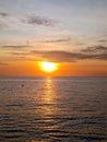 View of sunset sparkling on calm sea water at twilight