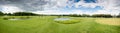 Panorama of golf course at cloudy day Royalty Free Stock Photo