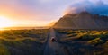 Gravel road at sunset with Vestrahorn mountain and a car driving, Iceland Royalty Free Stock Photo