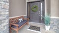 Panorama Gray front door entrance with wreath and sidelights under large transom window