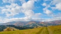 Panorama of green hills, trees and amazing clouds in Carpathian mountains in the autumn. Mountains landscape background Royalty Free Stock Photo