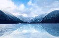 Panorama of Hallstatt lake outdoor with snow mountains with reflection in the water in Austria in Austrian alps