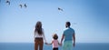 Panorama of happy beautiful family with kids walking together on sea beach during summer vacation. Freedom carefree