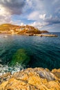Panorama of Harbour with vessels, boats, beach and lighthouse in Bali at sunrise, Rethymno, Crete, Greece. Famous summer resort in